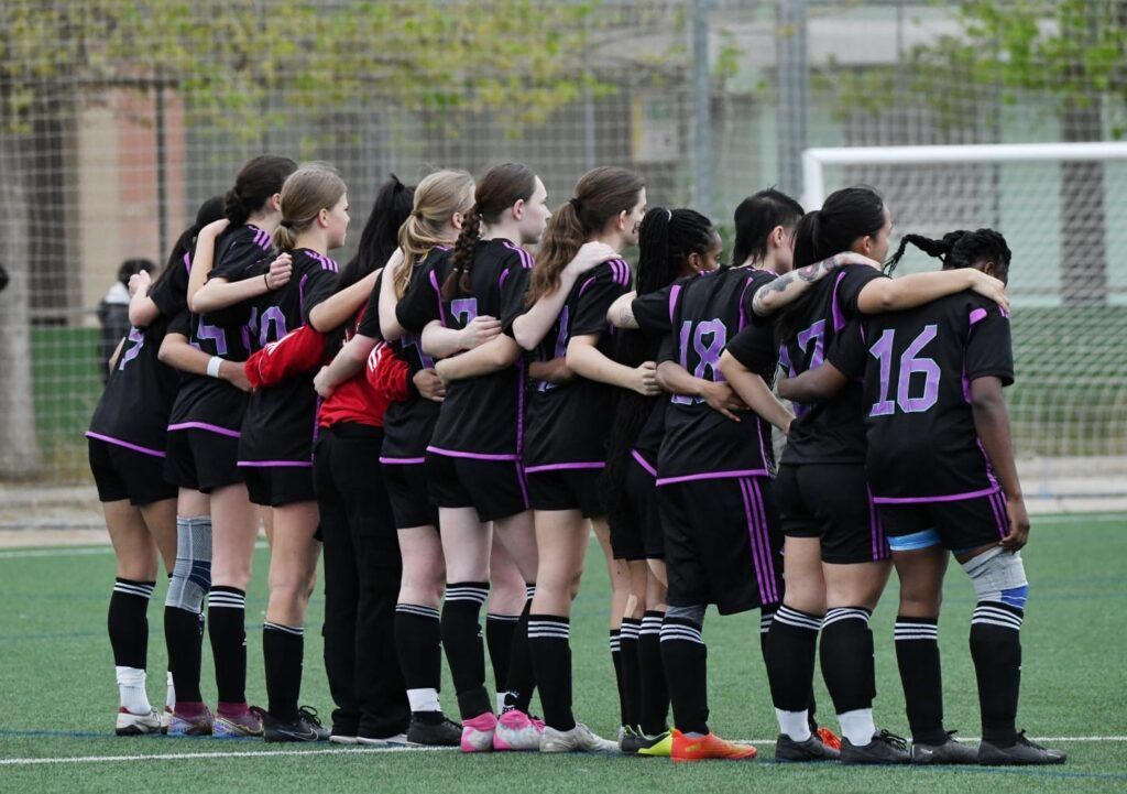 A group of girls in soccer uniforms creating opportunities internationally at Clark Woods LLP