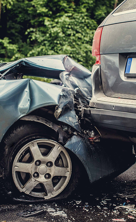 Close-up of a rear-end car accident showing significant vehicle damage after a collision